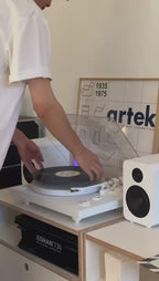 Polaris II Bluetooth Turntable — illuminated platter and 40W bookshelf speakers in use